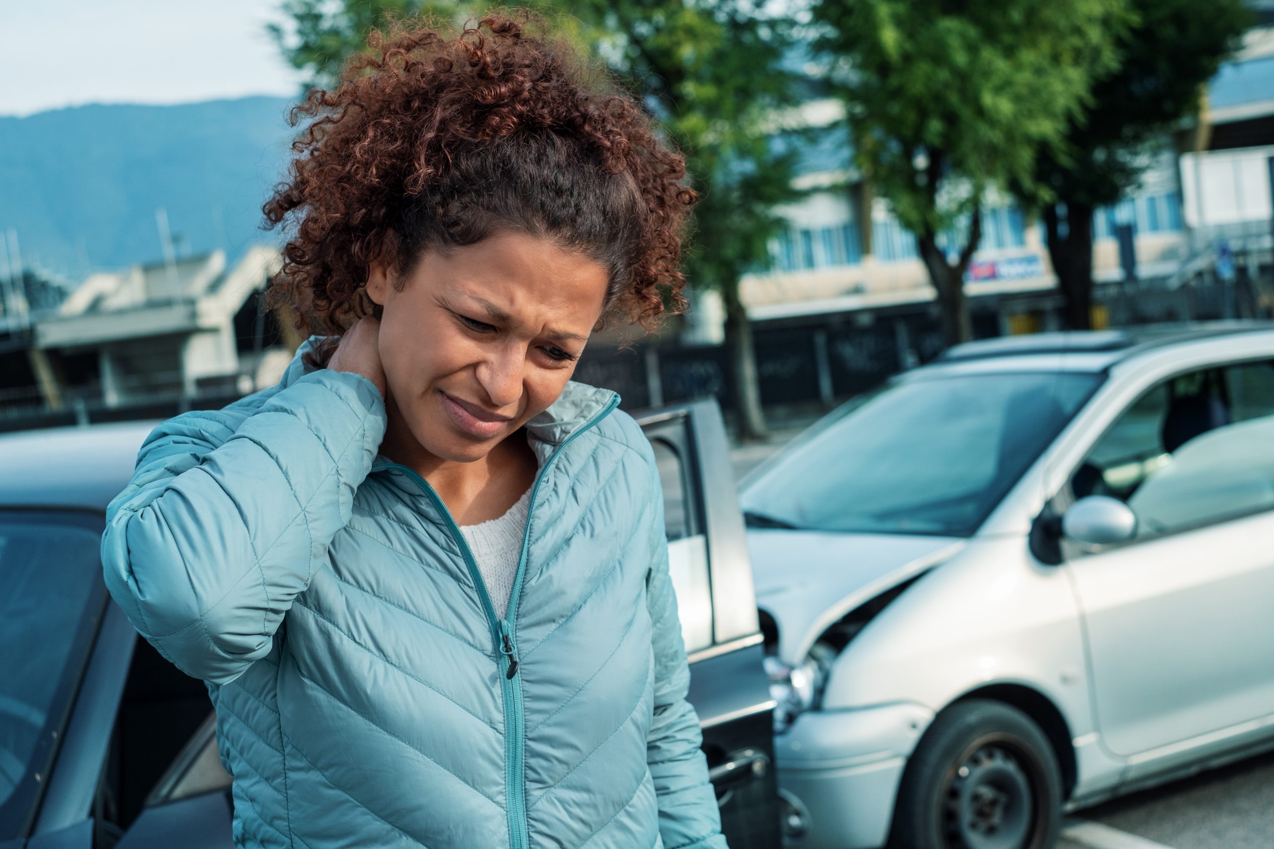 Woman suffering whiplash after bad cars pile up